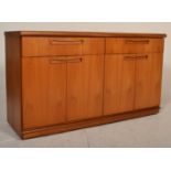 A retro mid 20th Century G Plan teak wood sideboard credenza raised on a plinth base having two