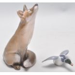 A Royal Copenhagen figurine of a fox with a upturned nose (no. 1475) together with a small