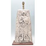 A vintage retro 1970's table lamp having a square faux stone body with carved knight decoration,