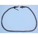 An 18ct white gold tennis bracelet set with round cut diamonds totalling approx 3.3cts. Measures