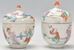 A pair of 19th Century Chinese egg cups and covers. Each egg cup having hand painted scenes of
