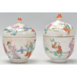 A pair of 19th Century Chinese egg cups and covers. Each egg cup having hand painted scenes of