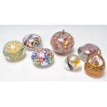 A mixed group of vintage 20th Century glass paperweights to include millefiore examples, Caithness