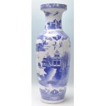 A large 20th Century Chinese floor standing blue and white vase depicting fauna and birds with a