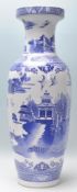 A large 20th Century Chinese floor standing blue and white vase depicting fauna and birds with a