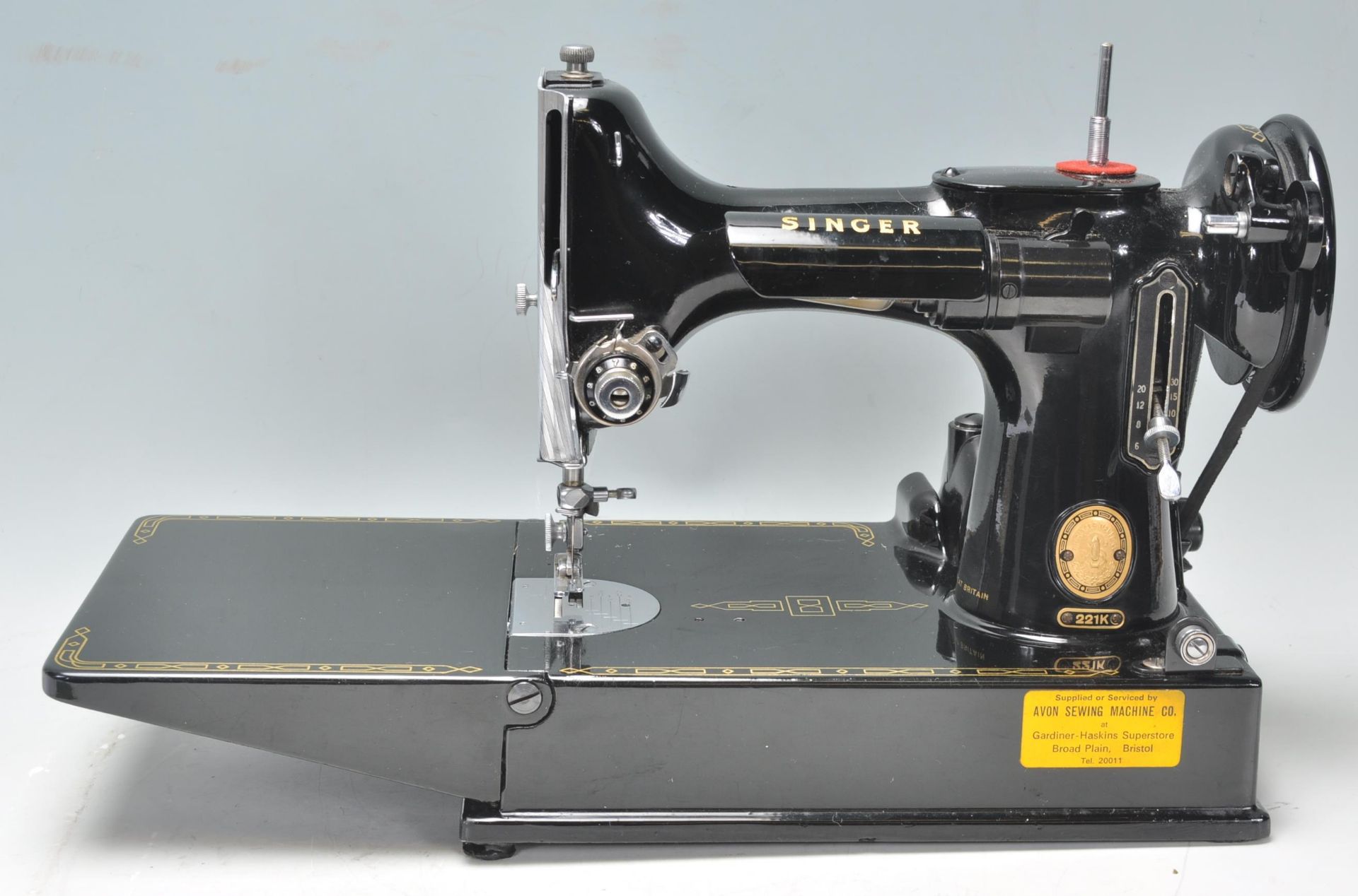 A vintage 20th Century Singer Featherweight convertible portable sewing machine model number 221k