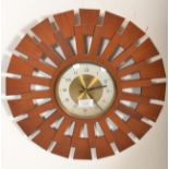 A good vintage retro 20th Century teak paneled sunburst wall clock having a brass face with white