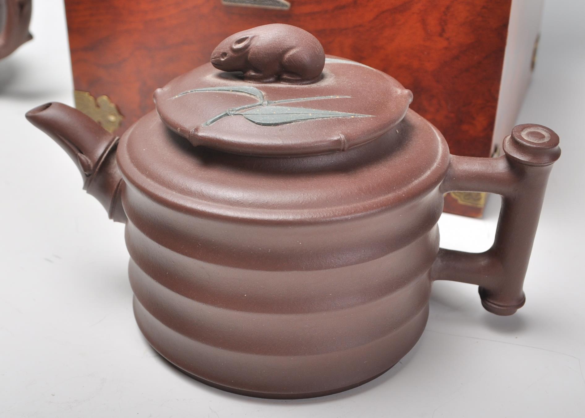 A Chinese Yixing clay teapot having carved decoration of a seated male figure with character marks - Image 13 of 13