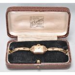 A vintage hallmarked 9ct gold cased ladies wrist watch having a mother of pearl face with Arabic