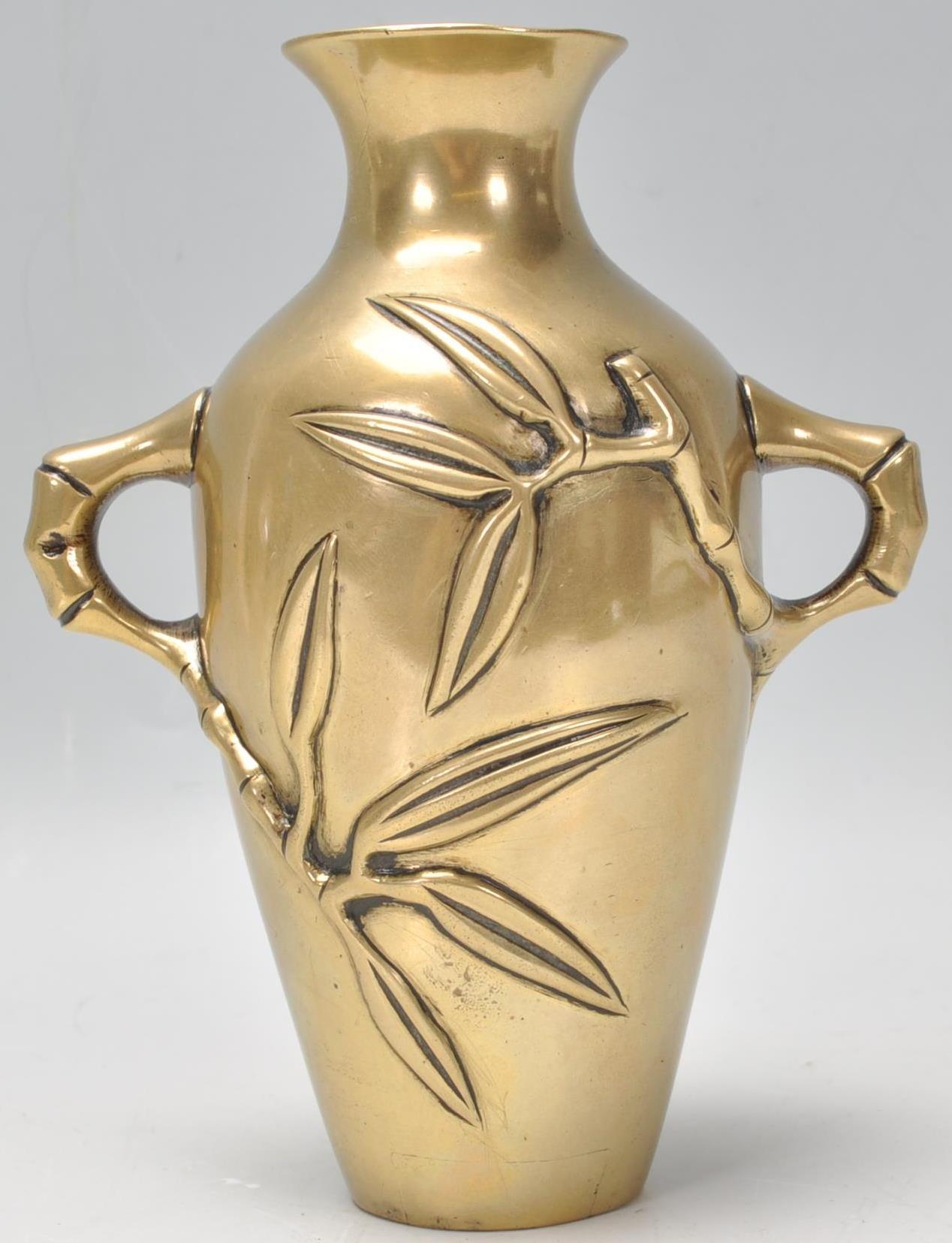 A believed 19th century Chinese brass / bronze twin handled vase having cast and embellished