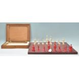 A superb 19th Century Victorian English bone and red stained first edition chess set with turned