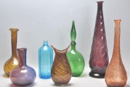 A mixed selection of vintage retro studio art glass vases of various colours and designs. Some twist