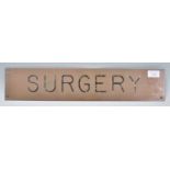 A vintage 20th Century enameled brass exterior medical surgery door / wall plate reading 'Surgery'.