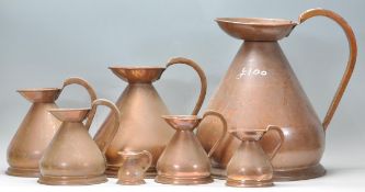 A set of large 19th century Victorian type copper cider jugs - measures. Each of graduating