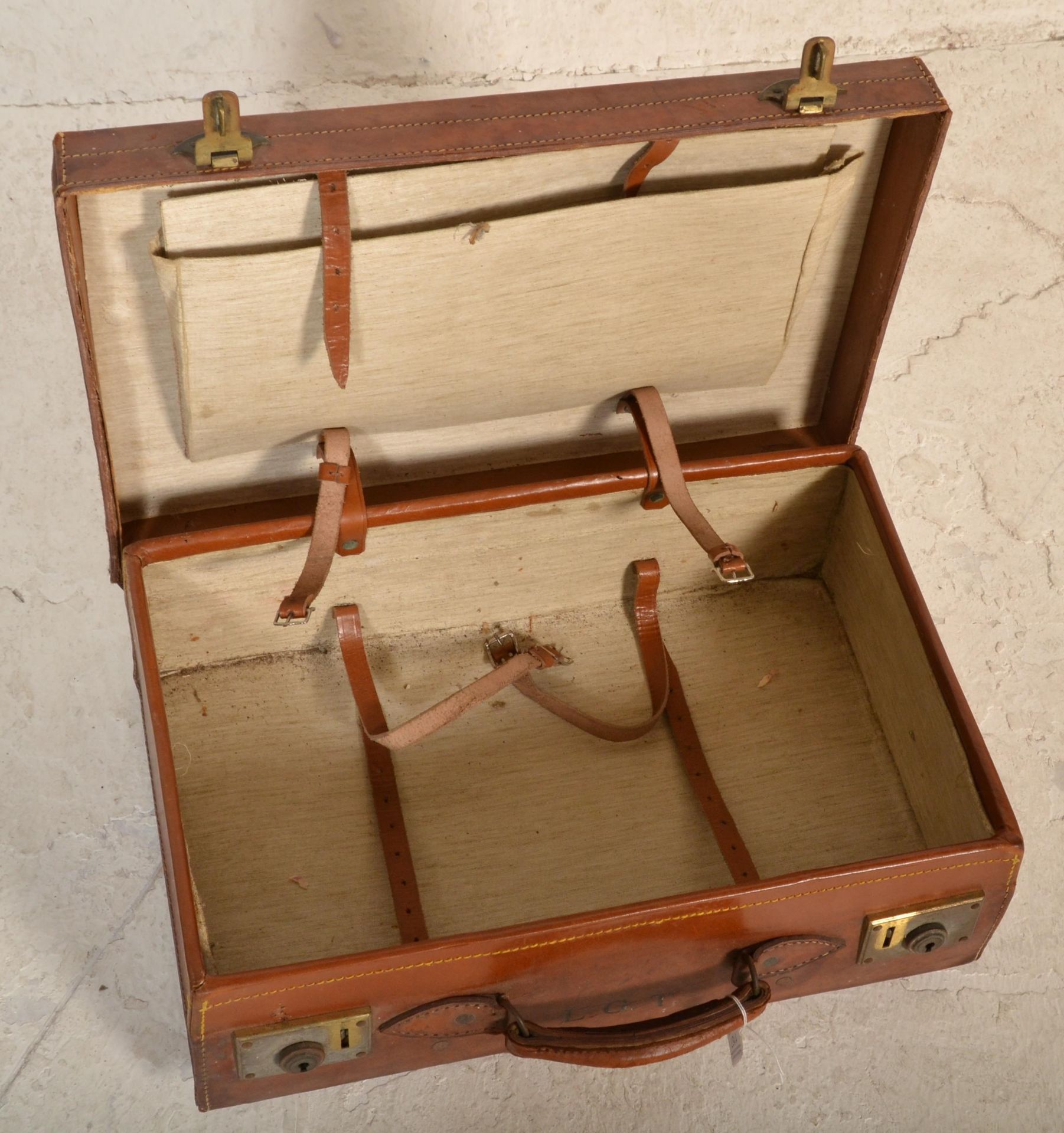 A good quality early 20th century leather suitcase with clasp locks and leather handles, remains - Image 4 of 4