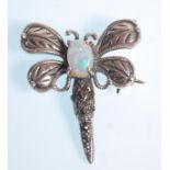 A stamped 925 silver brooch in the form of a dragon fly set with an opal and marcasites. Measures