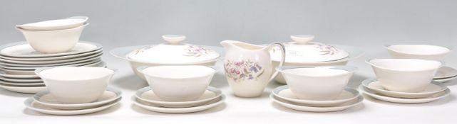A vintage retro Bristol pottery dinner service in the Lilybell pattern having blue rims with
