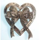 A stamped 925 silver heart brooch with bow decoration to the centre set with marcasites. Measures