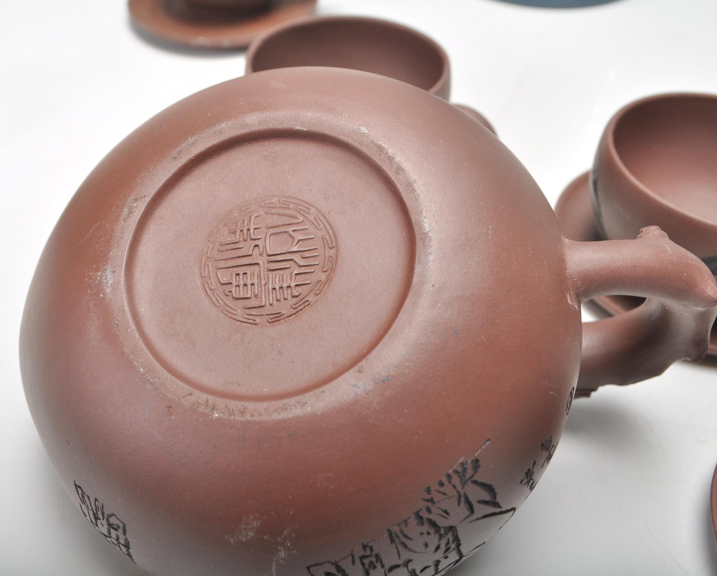 A Chinese Yixing clay teapot having carved decoration of a seated male figure with character marks - Image 9 of 13