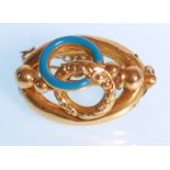 A 19th Century Victorian 18ct gold ladies brooch having a blue enamel decoration to rounded center