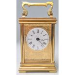 A good brass cased carriage clock with decorative applied brass work depicting birds and floral