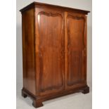 A Victorian 19th century mahogany bachelors wardrobe armoire. Raised on bracket feet with twin