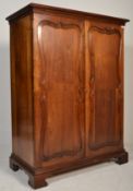 A Victorian 19th century mahogany bachelors wardrobe armoire. Raised on bracket feet with twin