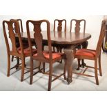 A 1920s mahogany extending dining table with cabriole legs along with 6 queen anne style dining