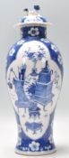 A 19th Century blue and white lidded vase being hand painted in the prunus pattern with a central
