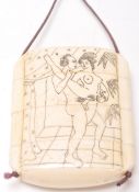 A vintage early 20th Century bone stacking toggle having an finley etched erotic scene to the