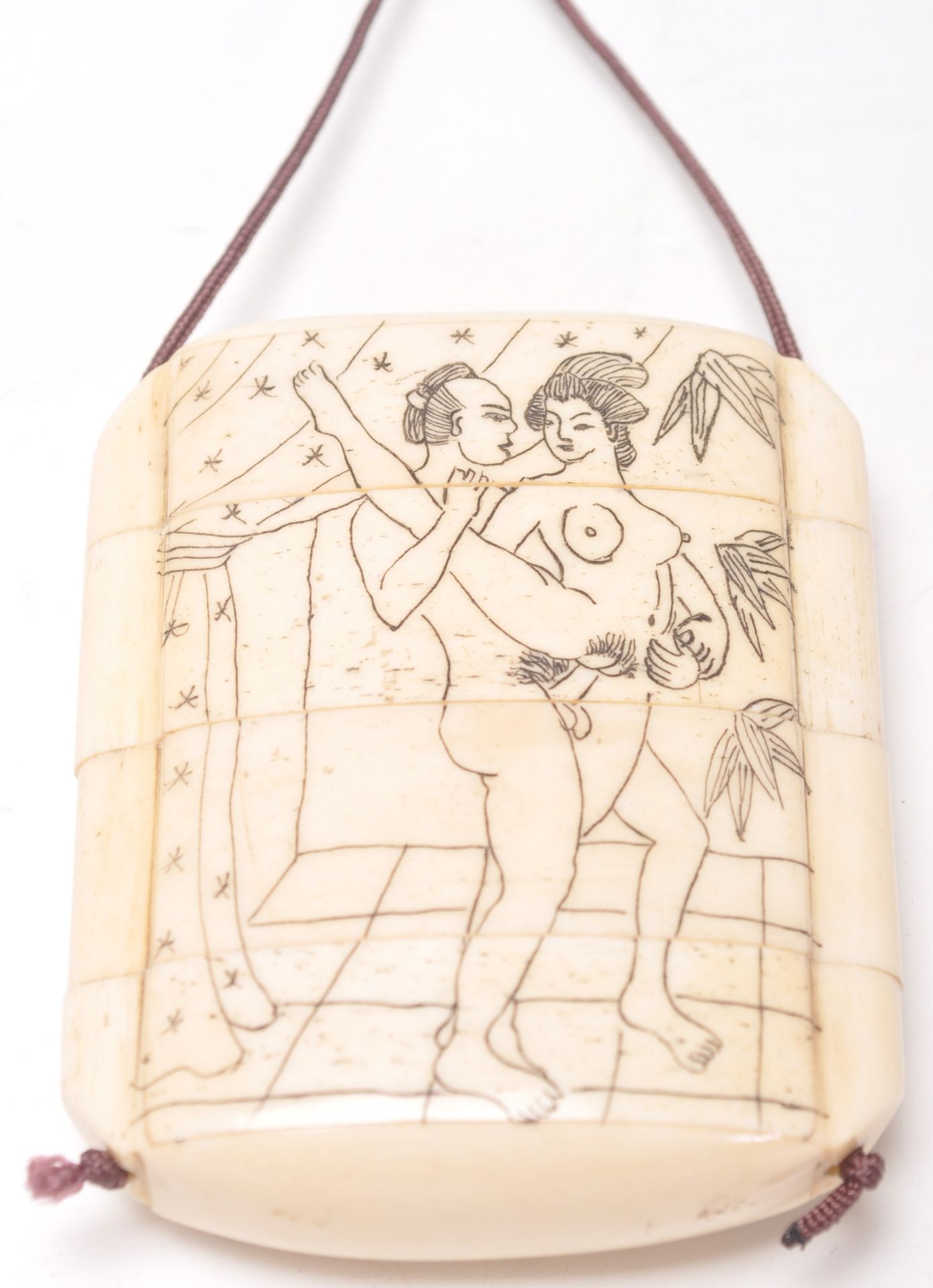 A vintage early 20th Century bone stacking toggle having an finley etched erotic scene to the