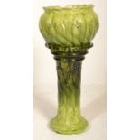 A 19th century / 20th century majolica planter in a two tone green colourway. Raised on shaped Art