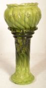 A 19th century / 20th century majolica planter in a two tone green colourway. Raised on shaped Art
