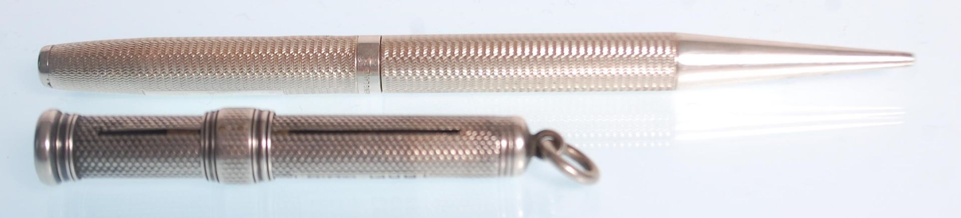 A good mid 20th Century silver hallmarked propelling pencil having an engine turned body being