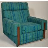 A retro mid century teak wood and upholstered easy chair / armchair. Upholstered in the original