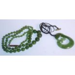 A vintage 20th Century Chinese green jade prayer bead necklace having a graduating set of round