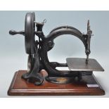 A good late 19th / early 20th Century Willcox & Gibbs sewing machine finished in black with gilt