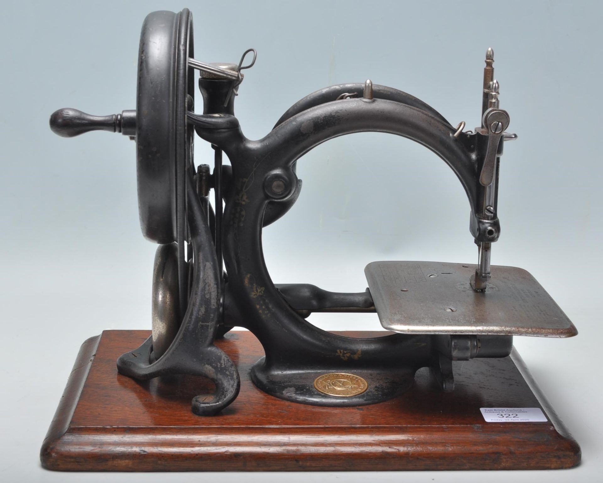 A good late 19th / early 20th Century Willcox & Gibbs sewing machine finished in black with gilt