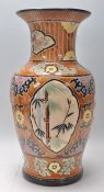 A large 20th Century Japanese vase of baluster form having a brown ground with incised florals and