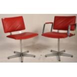 A set of 2 retro mid century chrome and red faux leather upholstered swivel chairs. To include