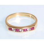 An English hallmarked 18ct yellow gold ladies ring set with alternating red and white round cut