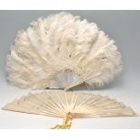 A lovely early 20th Century feather fan having mother of pearl sticks. Together with a 19th
