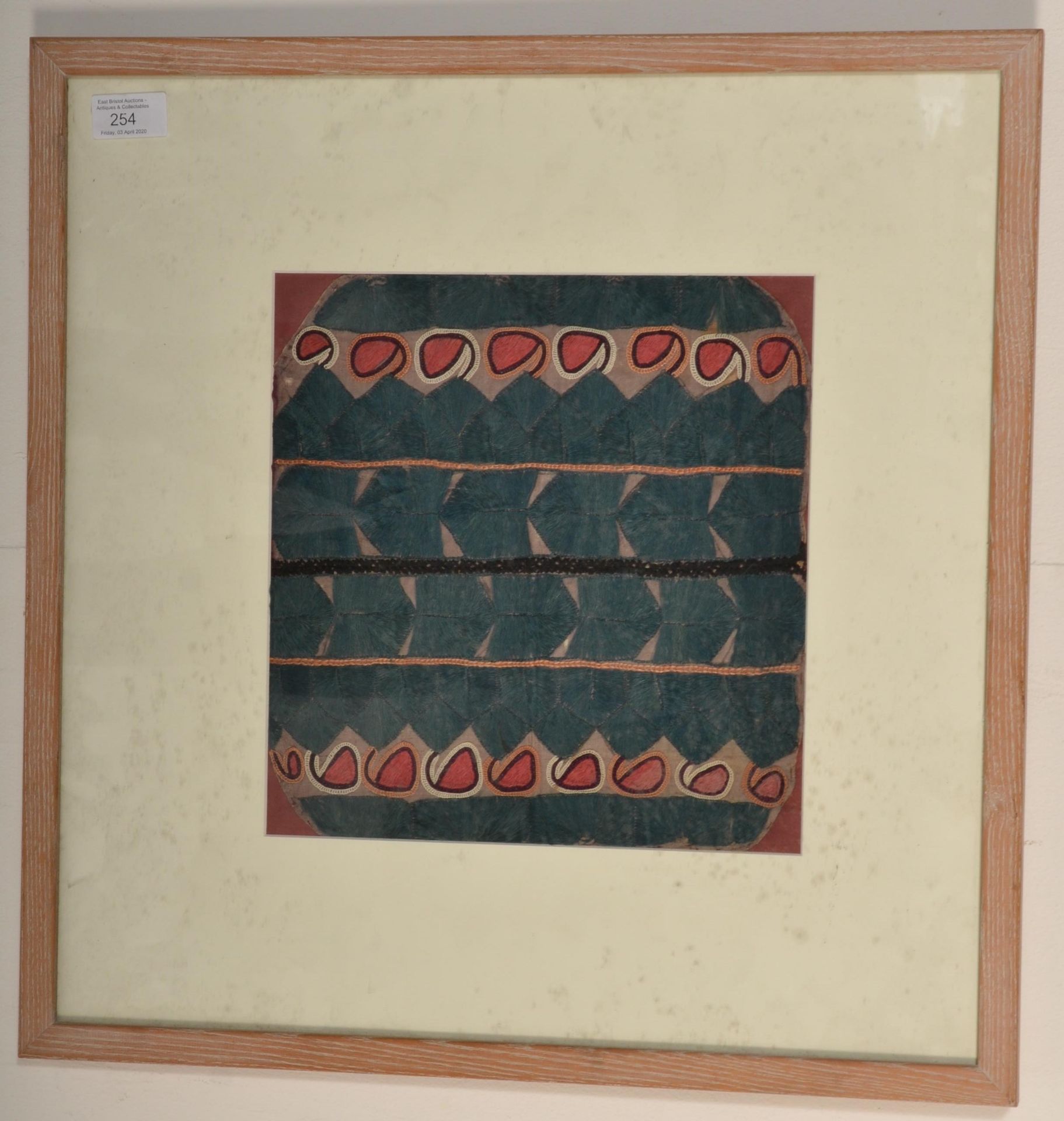 A 20th Century South American tribal folk art embroidered panel decorated with stylised geometric