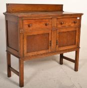 An early 20th Century Edwardian oak sideboard / credenza, gallery back with flared top over two