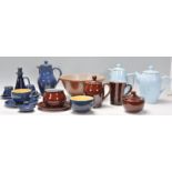 A collection of vintage retro pottery to include tea pots and coffee pots, a ceramic colander,