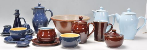 A collection of vintage retro pottery to include tea pots and coffee pots, a ceramic colander,