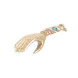 A late 19th Century Century unmarked gold hand charm having inlaid turquoise cabochons. Measures 2.