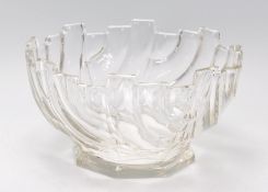 A vintage retro pressed glass centrepiece bowl raised on a footed base with a moulded geometric