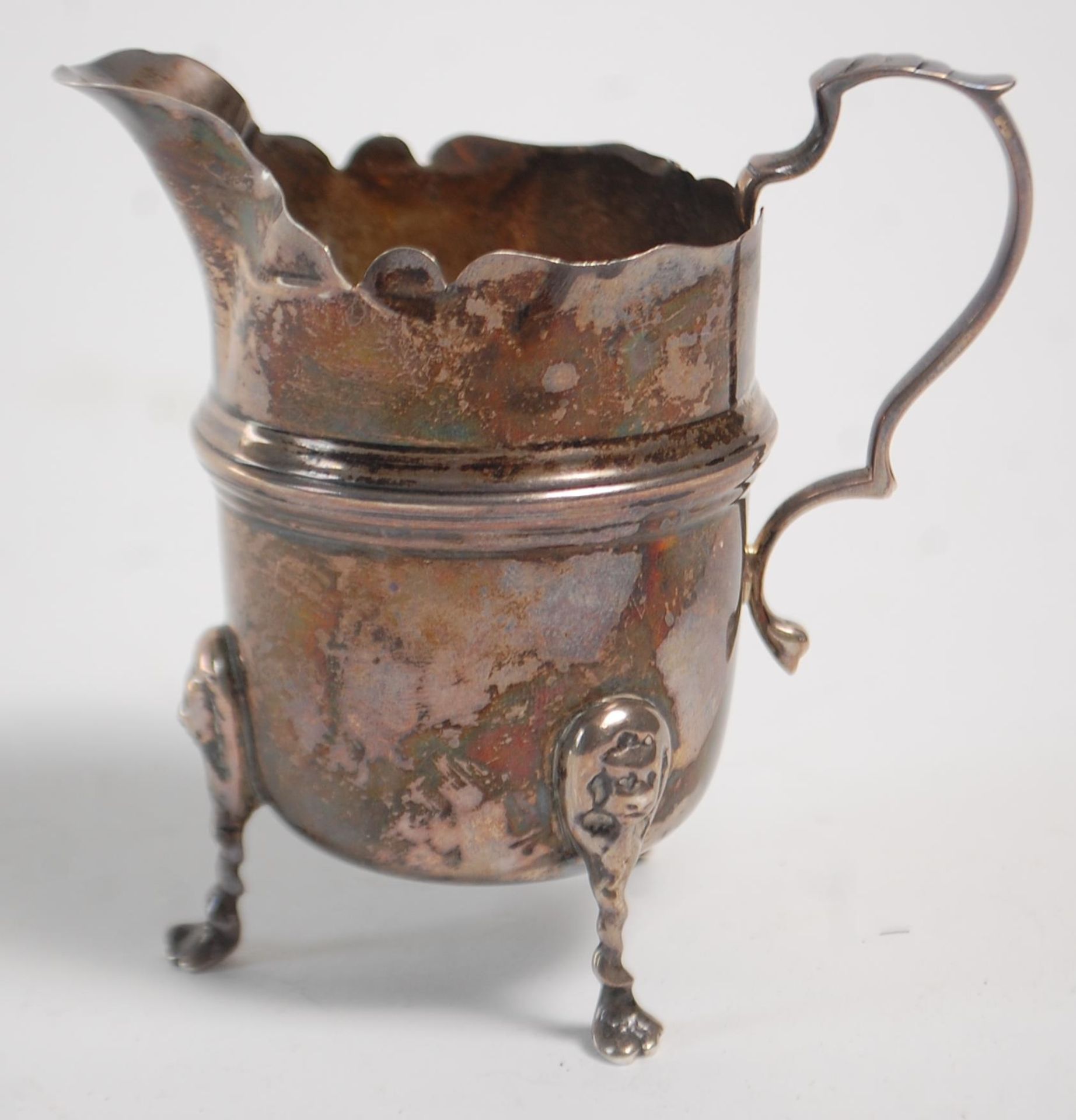 An early 20th Century silver hallmarked creamer jug having a flared top with banded center raised on - Image 3 of 9