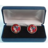 A pair of silver cufflinks having round panels having round enamelled panels decorated with